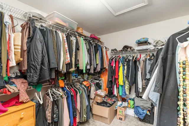 a view of walk in closet with clothes