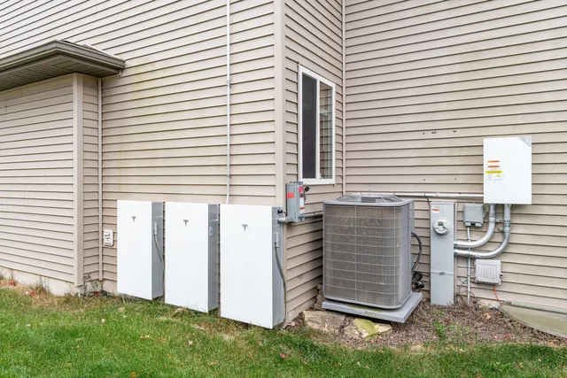 a backyard of a house with barbeque oven table and chairs