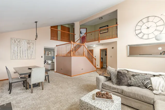 a living room with furniture and a ceiling fan