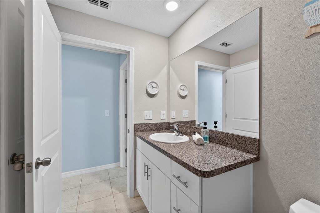 1728 Fred Ives Street Ruskin, FL 33570 - Photo 15 of 78 a bathroom with a granite countertop sink and a mirror