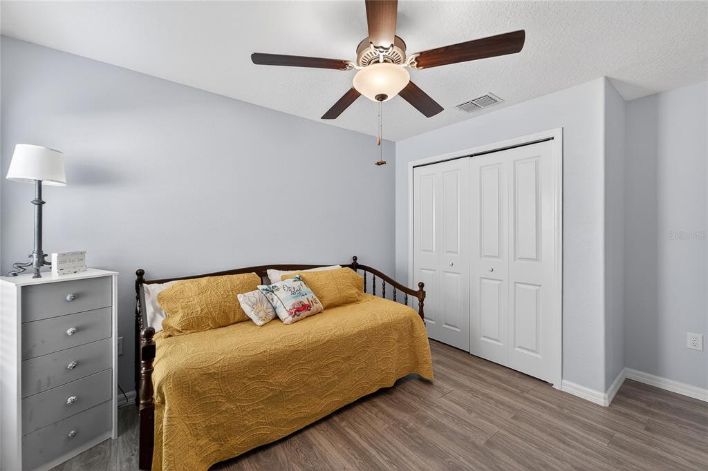 1728 Fred Ives Street Ruskin, FL 33570 - Photo 19 of 78 a bedroom with a bed and a ceiling fan