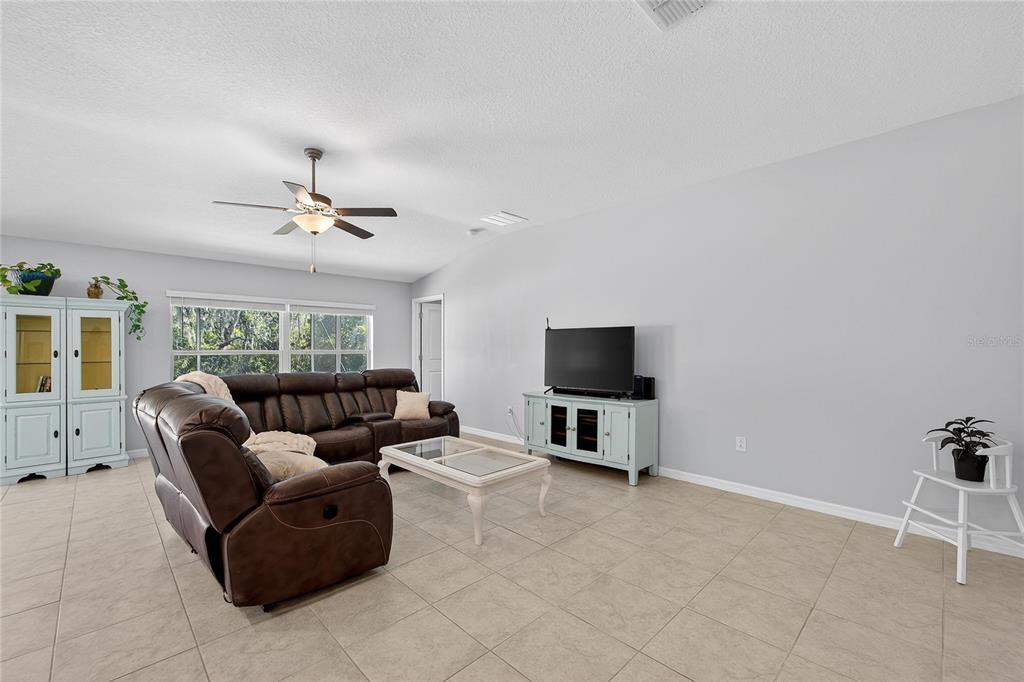 1728 Fred Ives Street Ruskin, FL 33570 - Photo 21 of 78 a living room with furniture and a flat screen tv