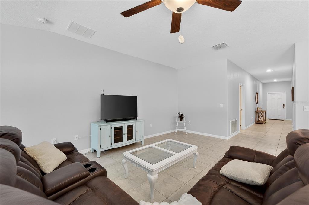 1728 Fred Ives Street Ruskin, FL 33570 - Photo 24 of 78 a living room with furniture and a flat screen tv