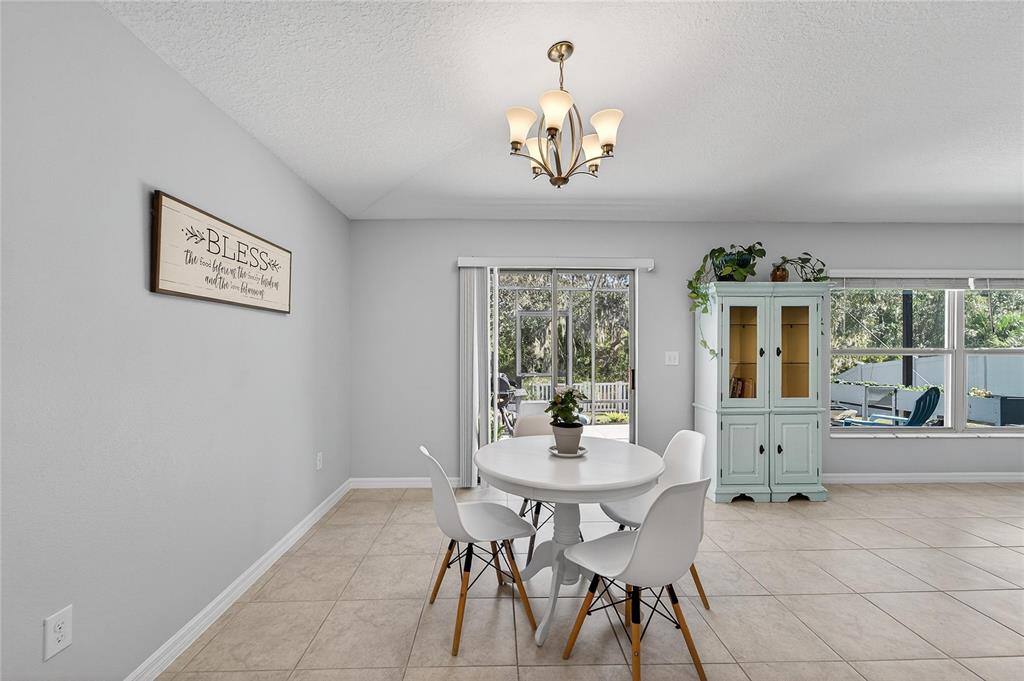1728 Fred Ives Street Ruskin, FL 33570 - Photo 26 of 78 a view of a dining room with furniture a chandelier and a window