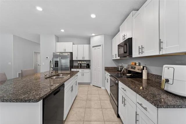 a view of swimming pool with seating area and furniture in the background