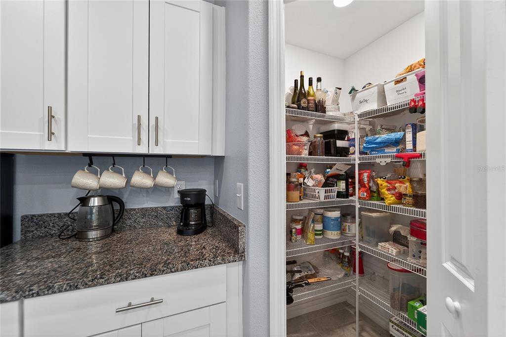 1728 Fred Ives Street Ruskin, FL 33570 - Photo 36 of 78 a kitchen with a refrigerator and cabinets