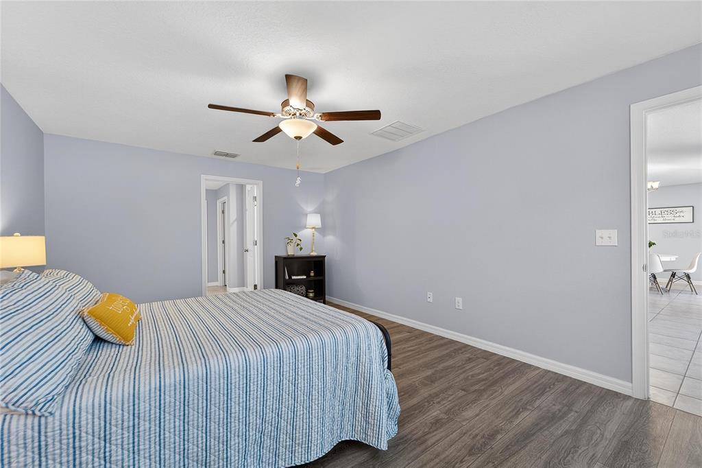 1728 Fred Ives Street Ruskin, FL 33570 - Photo 40 of 78 a bedroom with a bed and a chandelier