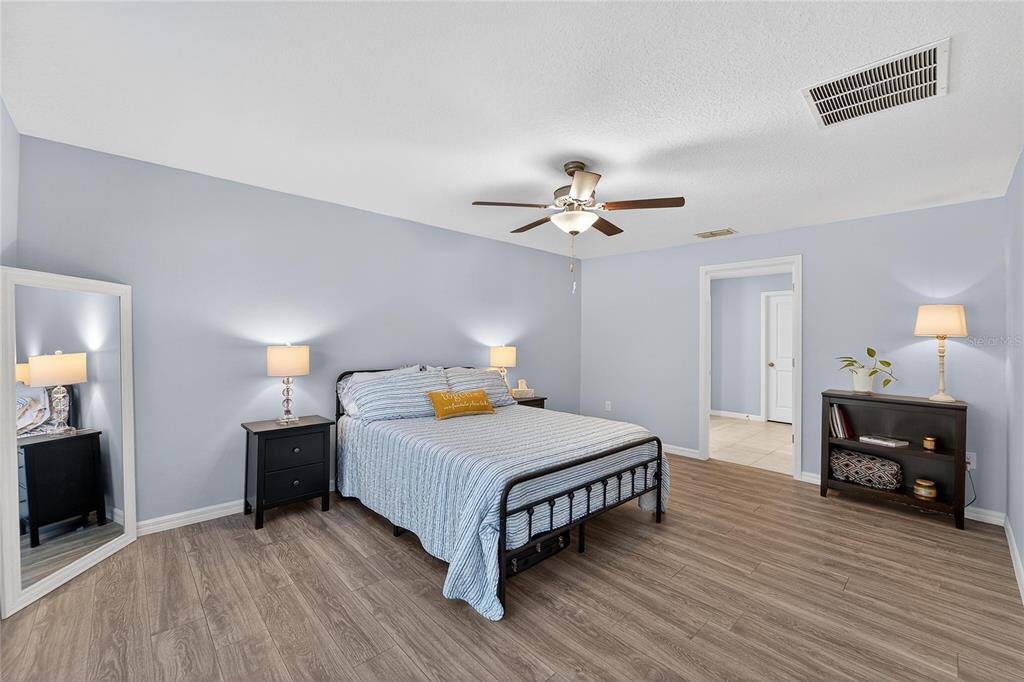 1728 Fred Ives Street Ruskin, FL 33570 - Photo 41 of 78 a bedroom with a bed and a chandelier