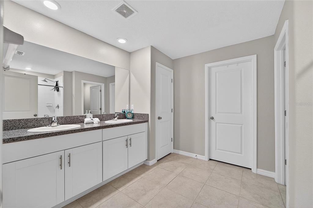 1728 Fred Ives Street Ruskin, FL 33570 - Photo 42 of 78 a bathroom with double sink and a mirror