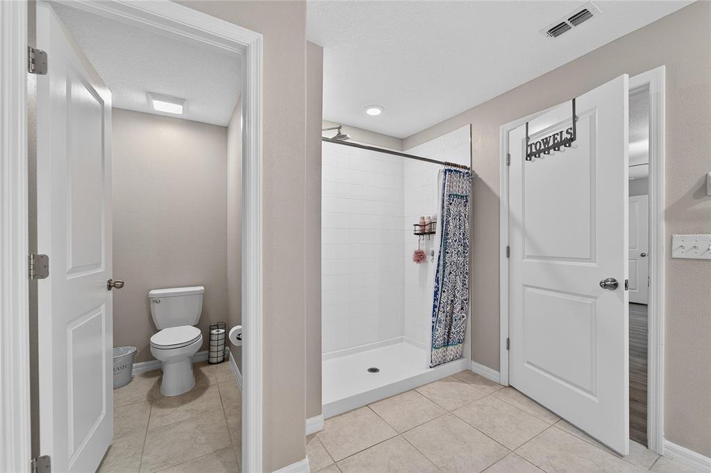 1728 Fred Ives Street Ruskin, FL 33570 - Photo 43 of 78 a bathroom with a shower and a toilet