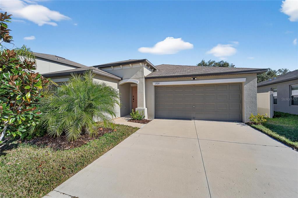 1728 Fred Ives Street Ruskin, FL 33570 - Photo 7 of 78 a view of a house with a yard and plants
