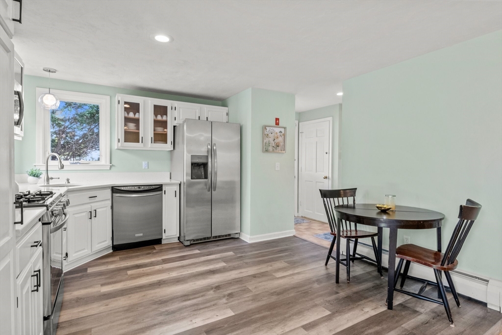 60 Tupper Avenue Sandwich, MA 02563 - Photo 9 of 35 a kitchen with stainless steel appliances kitchen island granite countertop a table chairs sink and cabinets