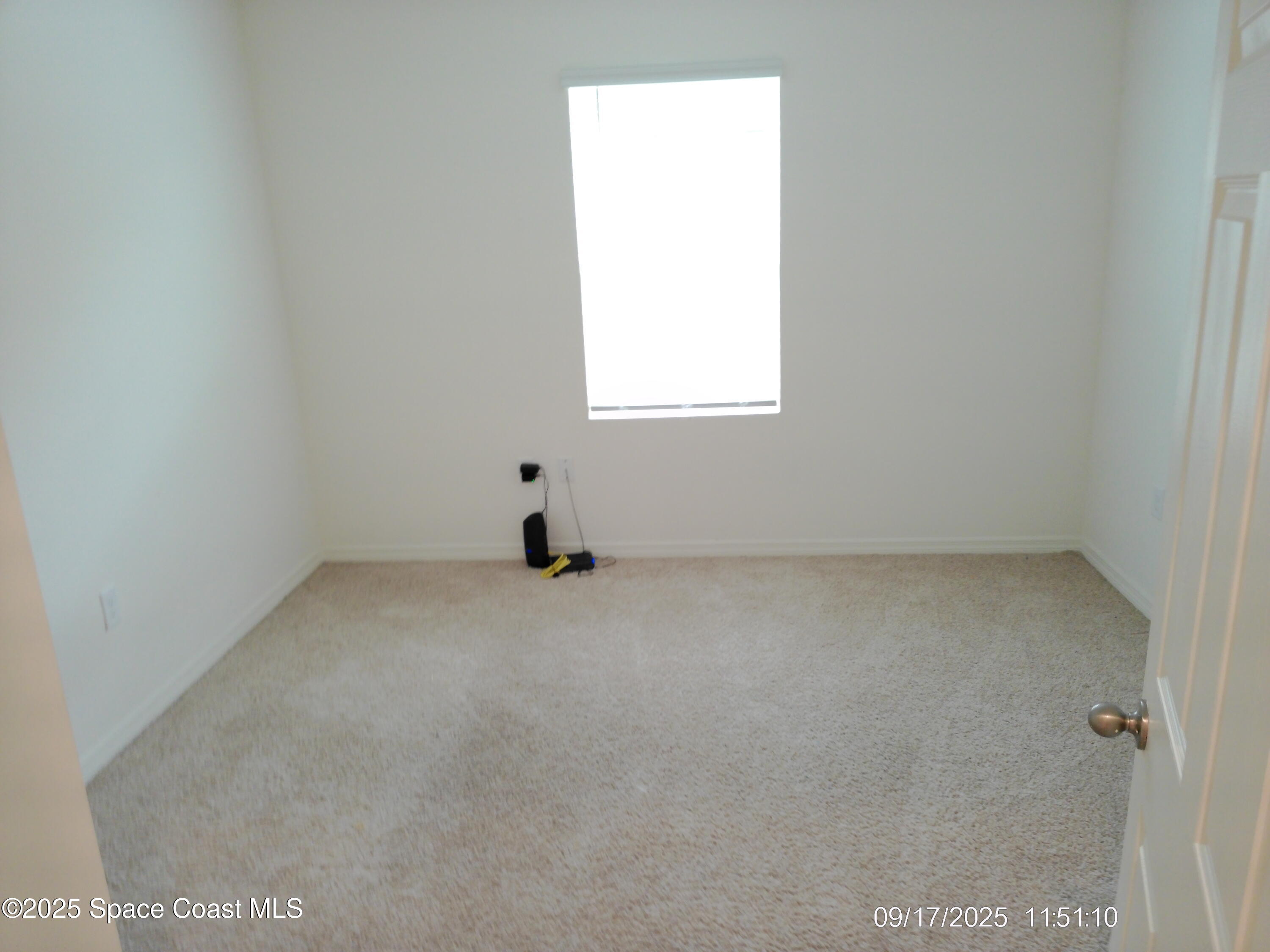 2073 Farmhouse Road Southeast Palm Bay, FL 32909 - Photo 11 of 14 an empty room with a window