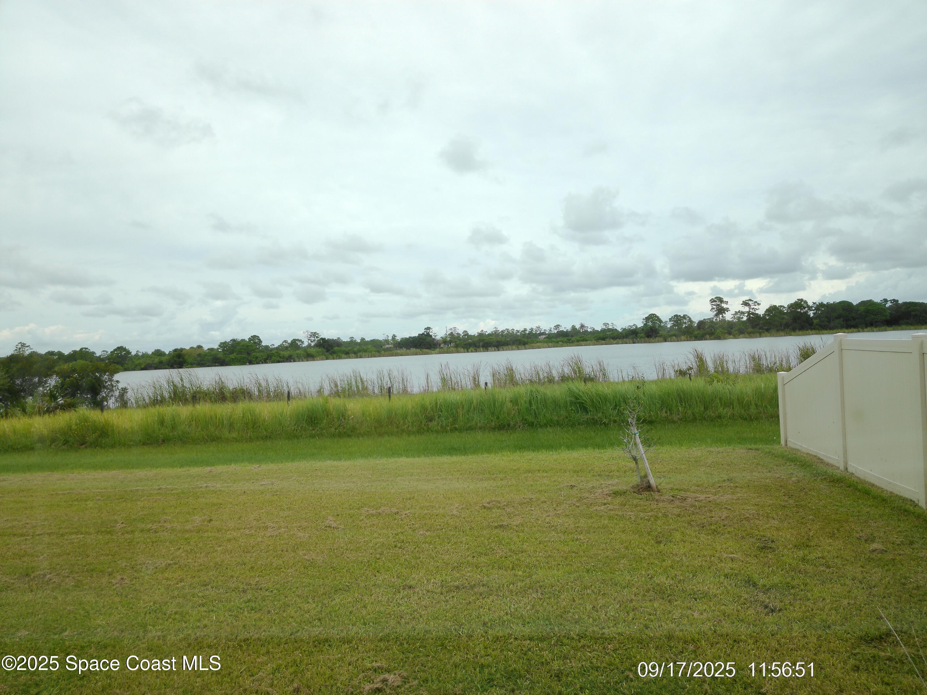 2073 Farmhouse Road Southeast Palm Bay, FL 32909 - Photo 12 of 14 a view of a lake and a yard
