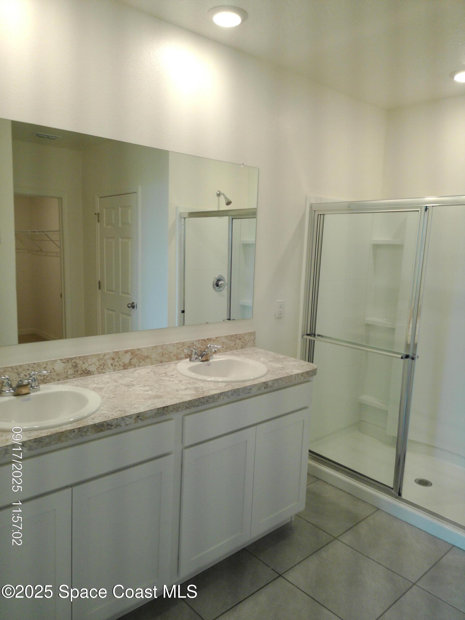 2073 Farmhouse Road Southeast Palm Bay, FL 32909 - Photo 13 of 14 a bathroom with a granite countertop sink a mirror and a vanity