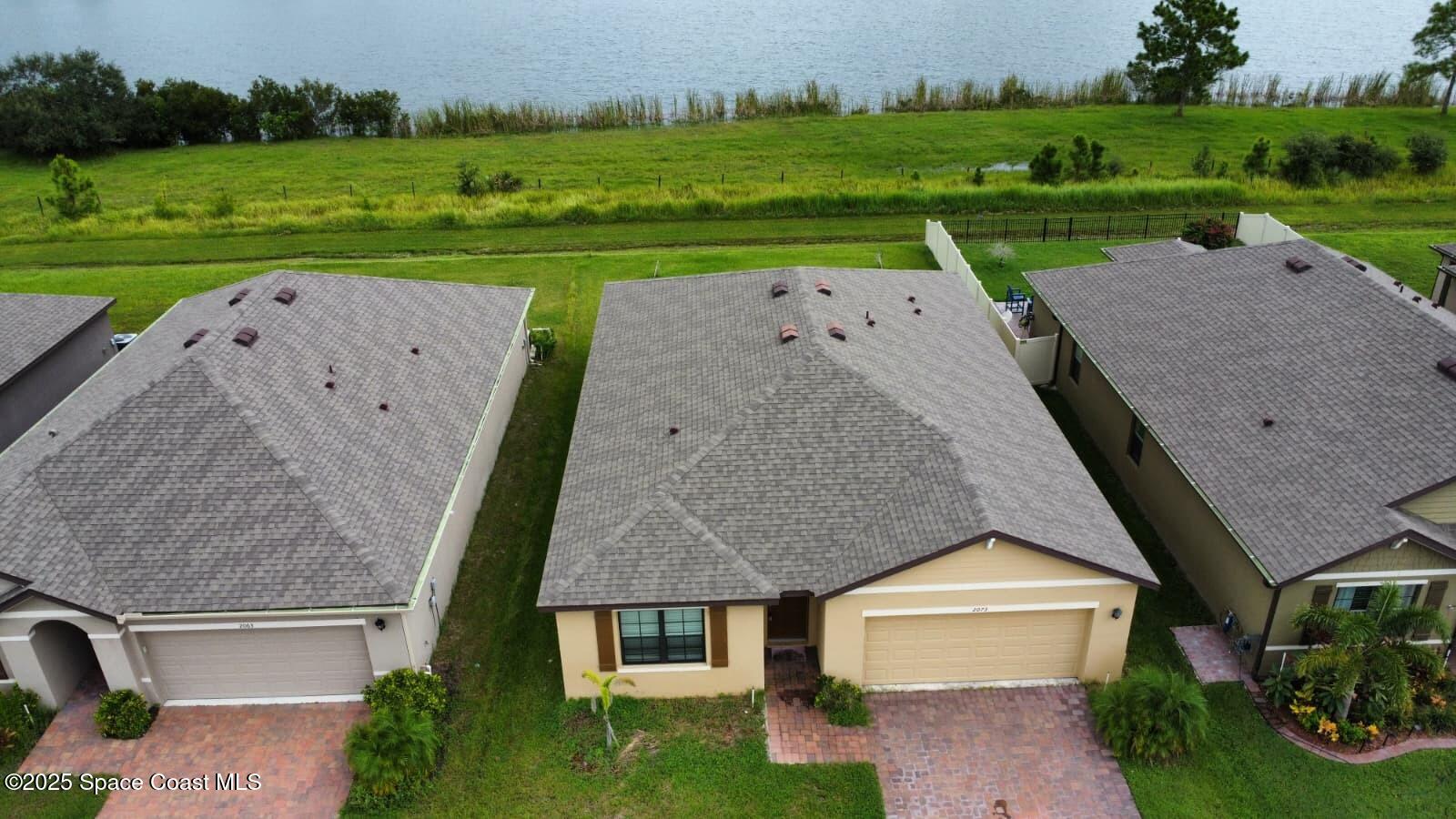 2073 Farmhouse Road Southeast Palm Bay, FL 32909 - Photo 2 of 14 an aerial view of a house with big yard