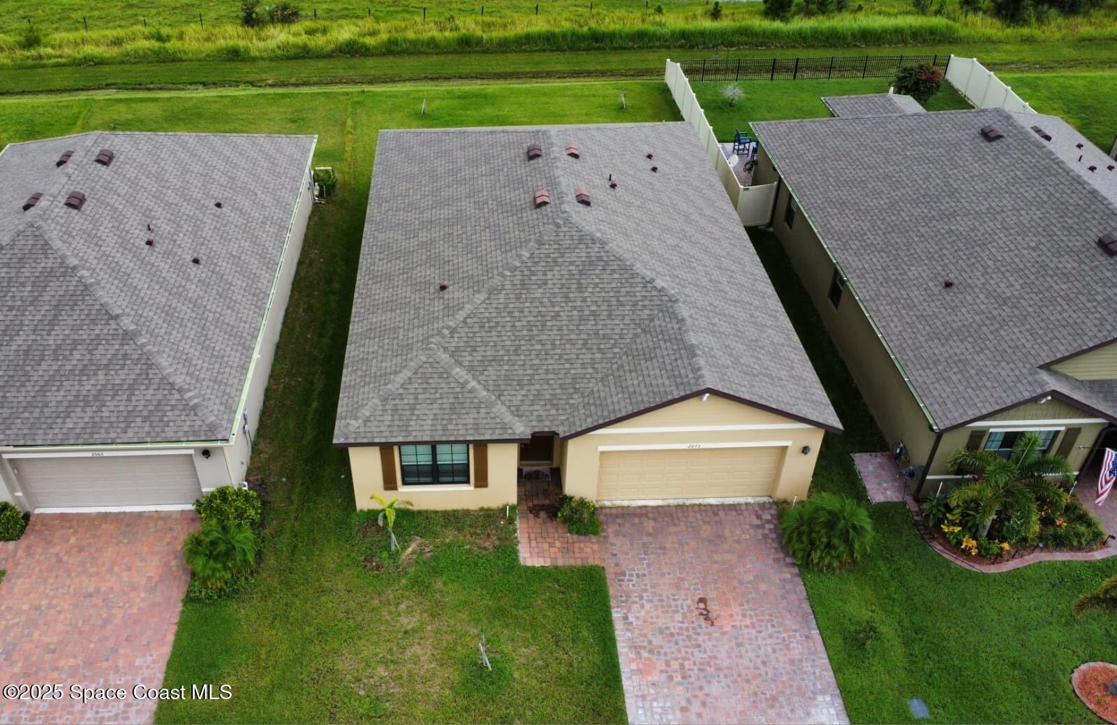 2073 Farmhouse Road Southeast Palm Bay, FL 32909 - Photo 4 of 14 an aerial view of a house with big yard