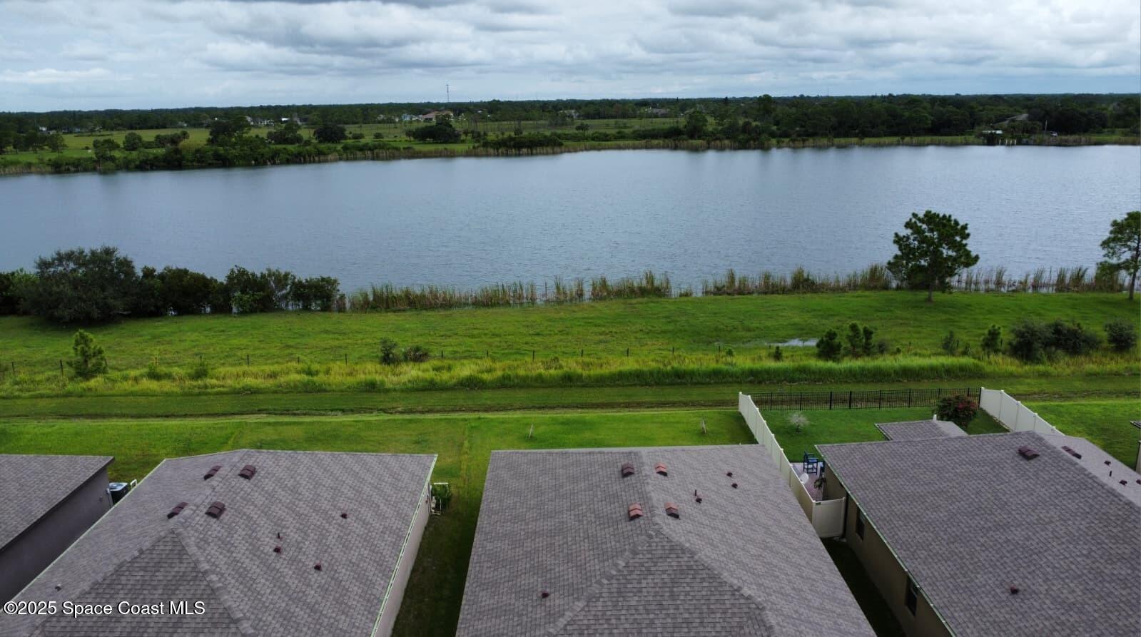 2073 Farmhouse Road Southeast Palm Bay, FL 32909 - Photo 6 of 14 an aerial view of a golf course with a lake view