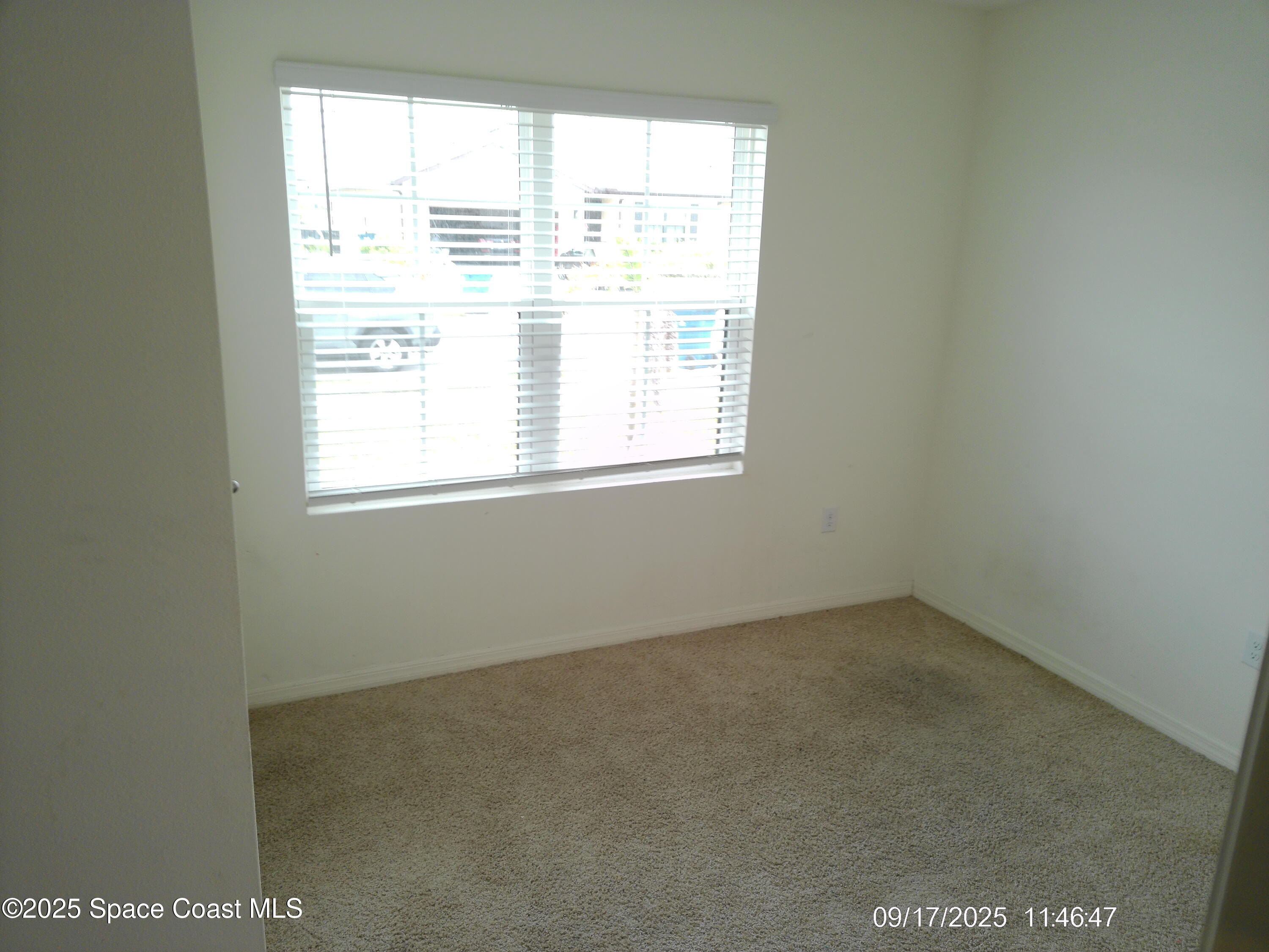 2073 Farmhouse Road Southeast Palm Bay, FL 32909 - Photo 9 of 14 an empty room with a window