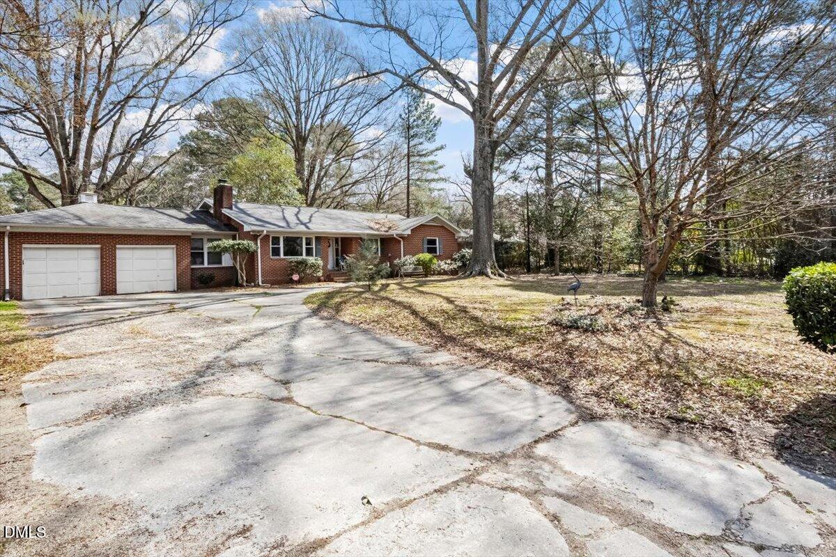 3107 Dixon Road Durham, NC 27707 - Photo 27 of 35 a view of a white house with a yard covered in snow
