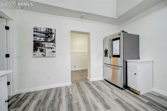 a view of kitchen with furniture and refrigerator