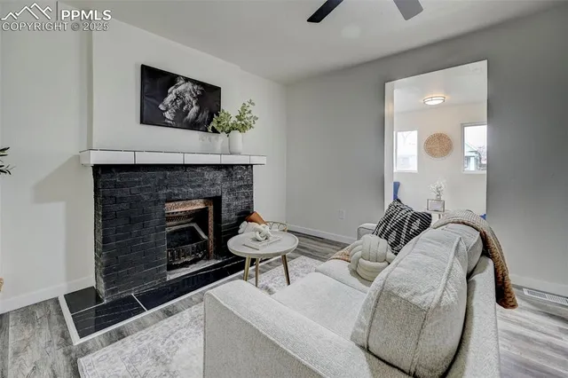a living room with furniture a flat screen tv and a fireplace