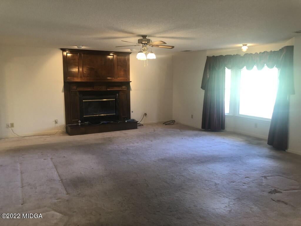 1589 Hamlin Road Lizella, GA 31052 - Photo 2 of 25 a view of an empty room with a fireplace