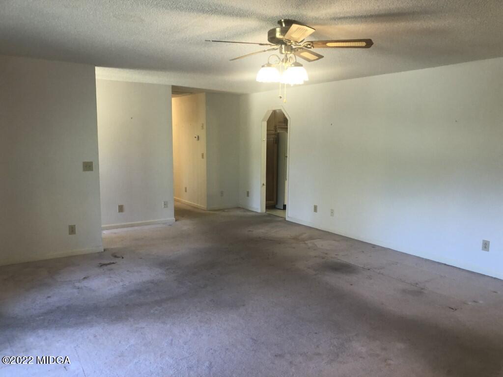 1589 Hamlin Road Lizella, GA 31052 - Photo 3 of 25 an empty room with chandelier fan