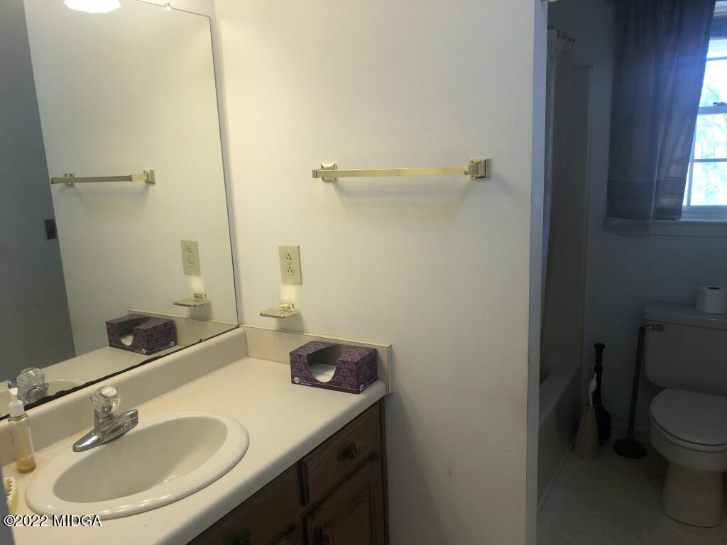 1589 Hamlin Road Lizella, GA 31052 - Photo 10 of 25 a bathroom with a sink toilet and a mirror