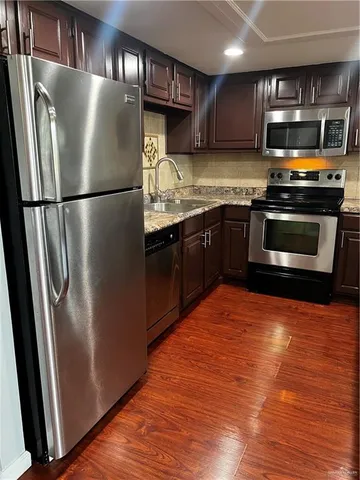 a kitchen with stainless steel appliances granite countertop a refrigerator stove and sink