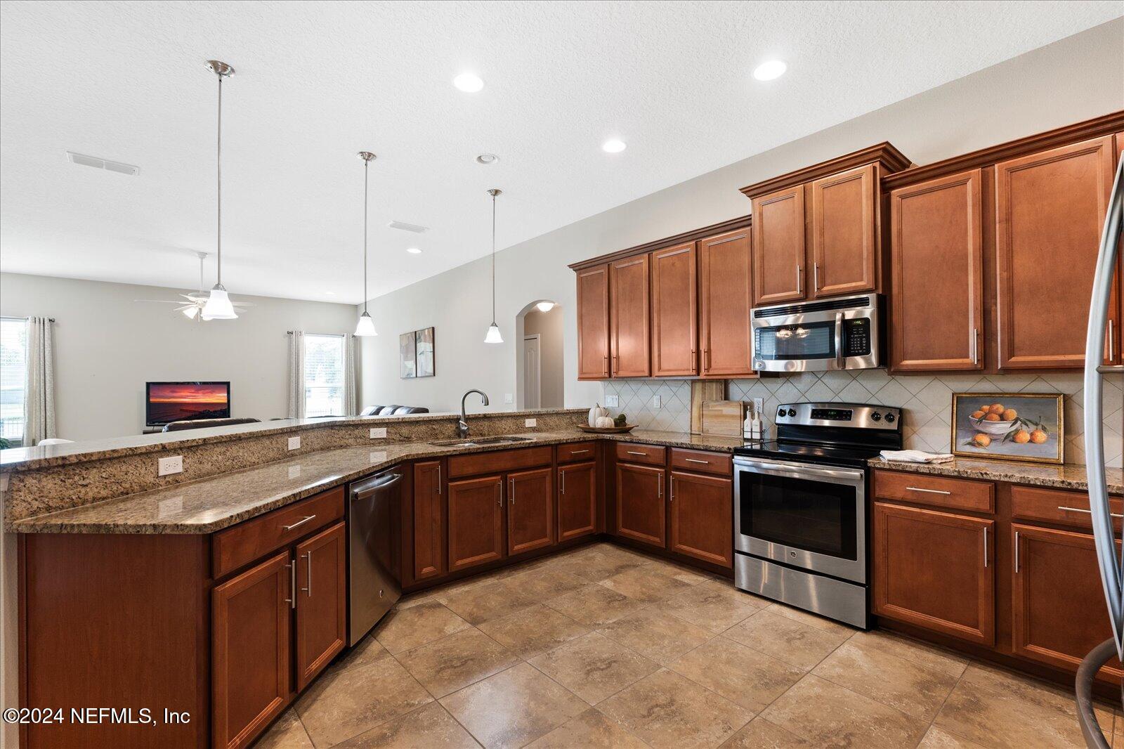 273 Parkwood Circle St. Augustine, FL 32086 - Photo 12 of 34 a large kitchen with stainless steel appliances granite countertop a stove sink and microwave