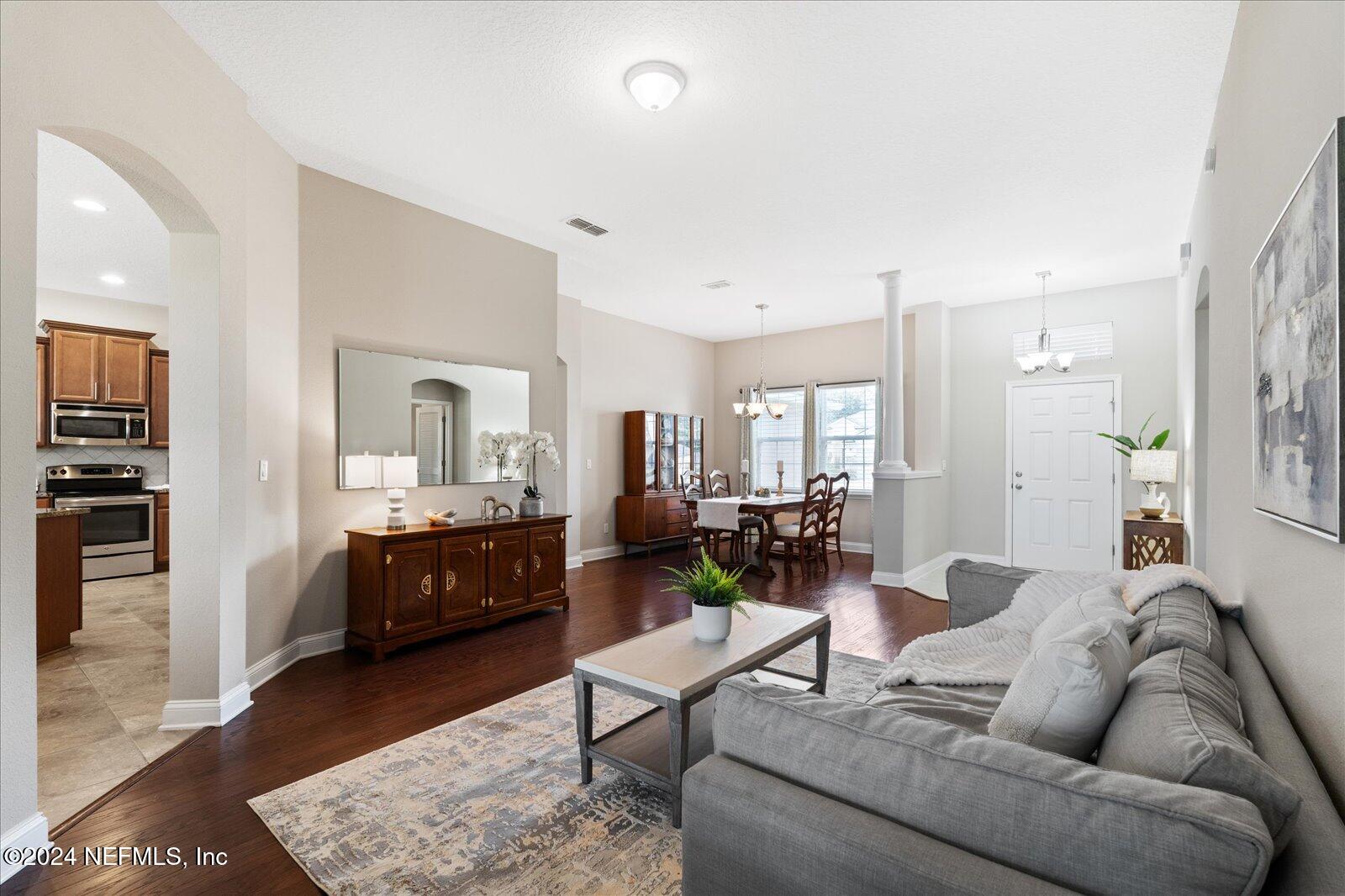 273 Parkwood Circle St. Augustine, FL 32086 - Photo 2 of 34 a living room with furniture a rug kitchen view and a window