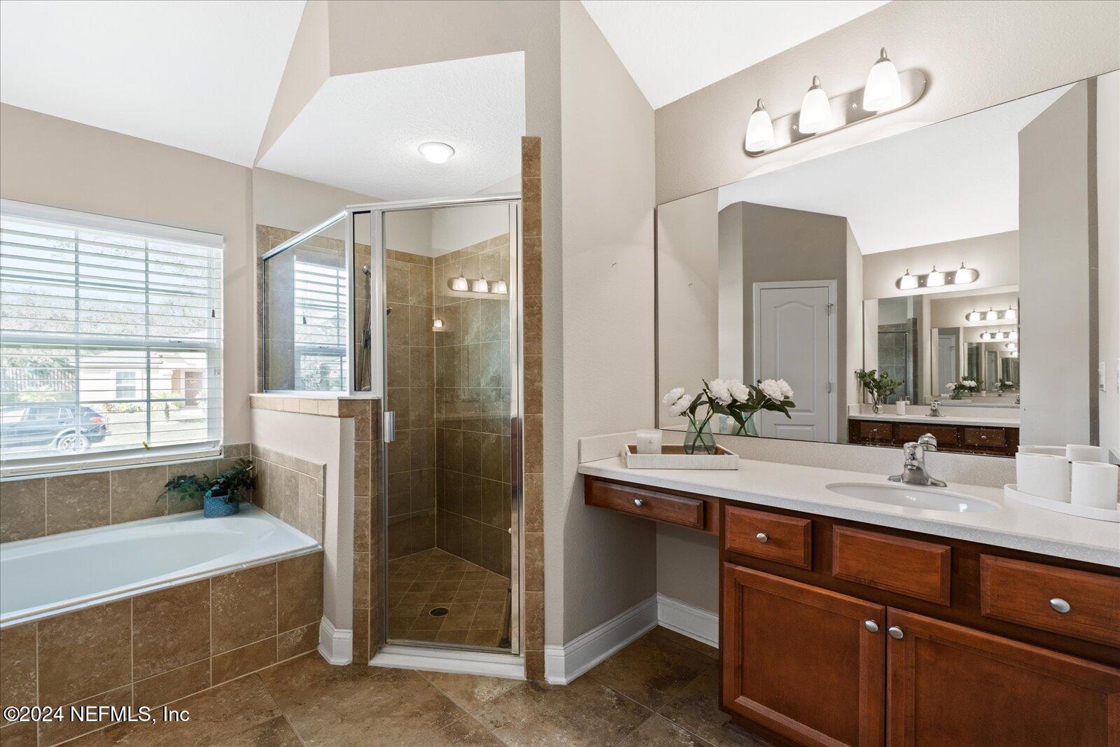 273 Parkwood Circle St. Augustine, FL 32086 - Photo 21 of 34 a bathroom with a tub sink double vanity and a mirror