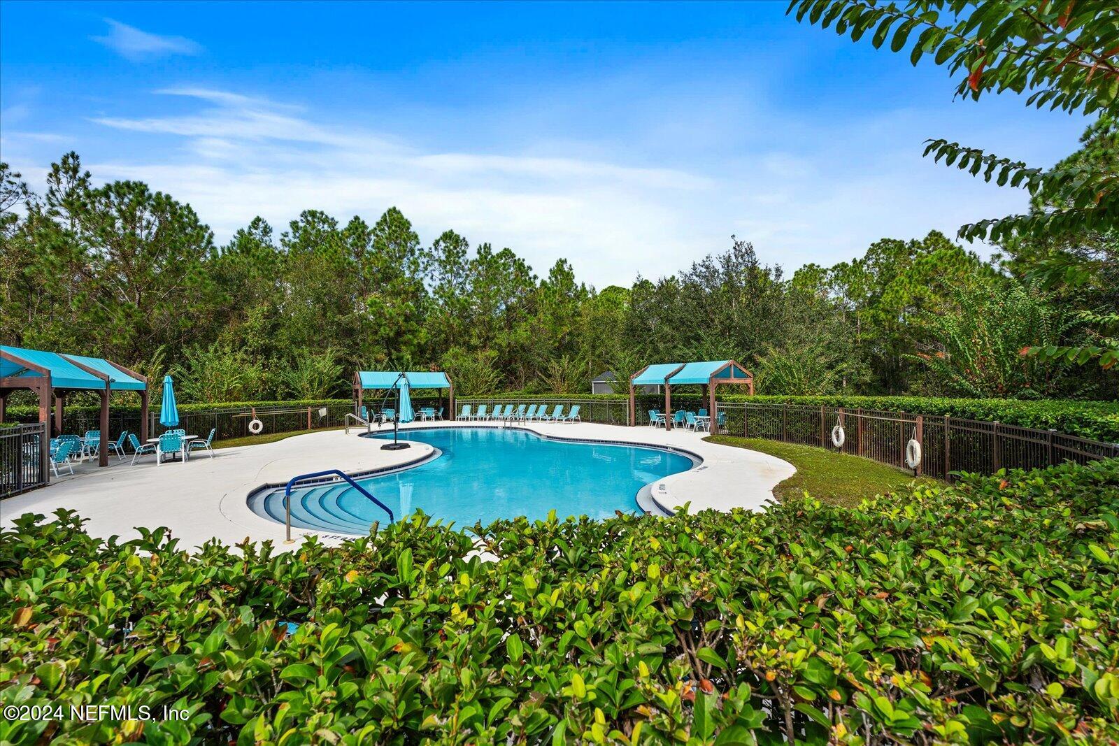 273 Parkwood Circle St. Augustine, FL 32086 - Photo 30 of 34 a view of a swimming pool with a yard