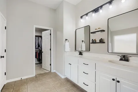 a bathroom with a double vanity sink and mirror