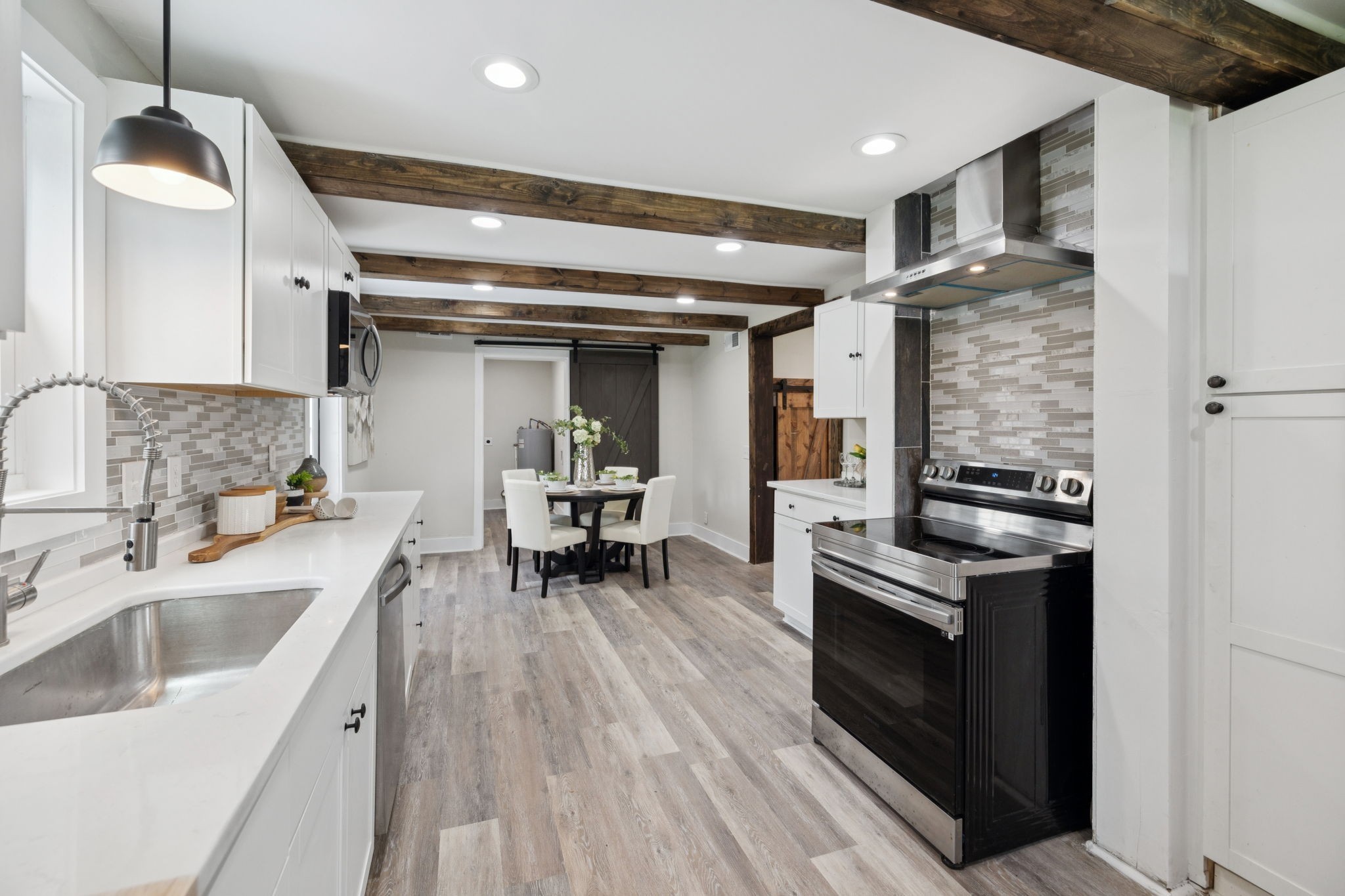 511 North Main Street Morrison, TN 37357 - Photo 20 of 41 a kitchen with a sink dishwasher a stove and a refrigerator with wooden floor