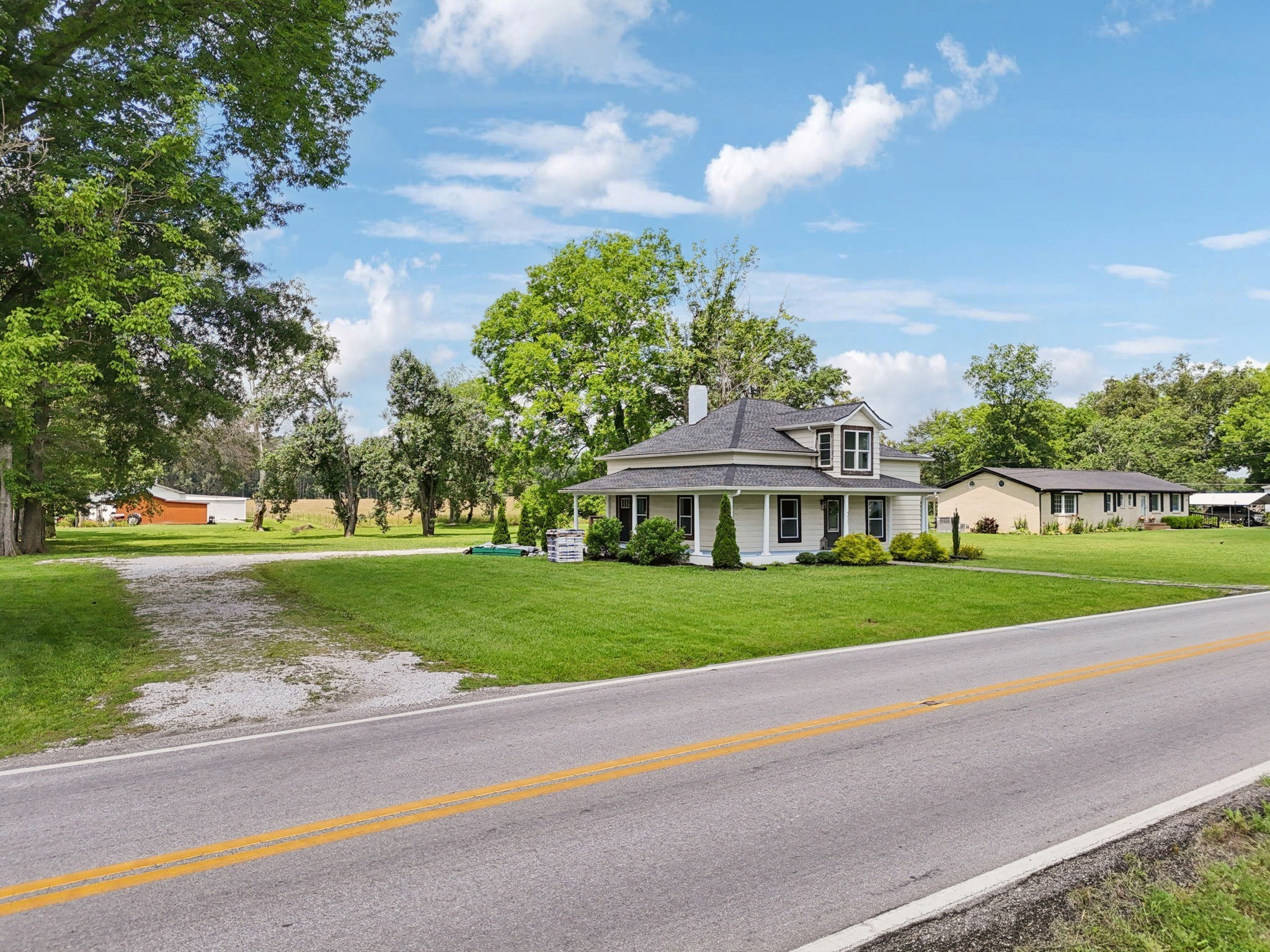 511 North Main Street Morrison, TN 37357 - Photo 5 of 41 a view of a house with a big yard plants and large trees