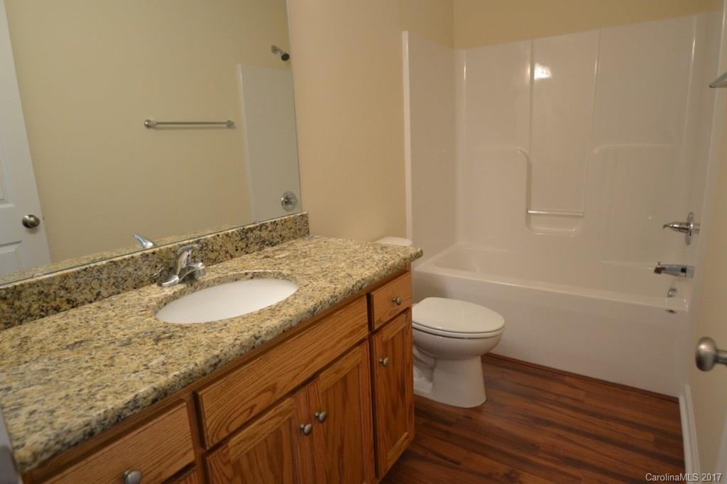 3835 Lee Moore Road, Unit 3835 Maiden, NC 28650 - Photo 16 of 19 a bathroom with a granite countertop sink toilet and shower