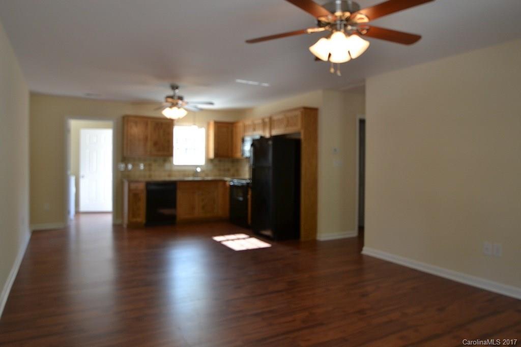 3835 Lee Moore Road, Unit 3835 Maiden, NC 28650 - Photo 3 of 19 a view of kitchen with granite countertop cabinets and refrigerator