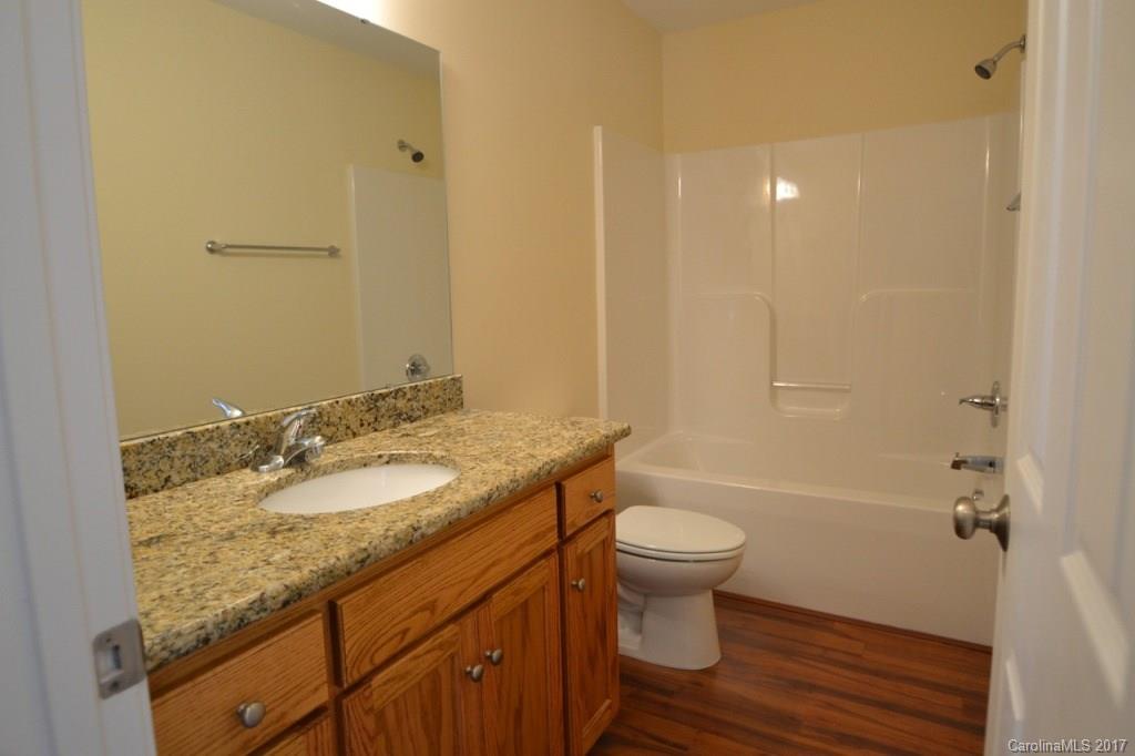 3835 Lee Moore Road, Unit 3835 Maiden, NC 28650 - Photo 5 of 19 a bathroom with a granite countertop sink toilet and shower