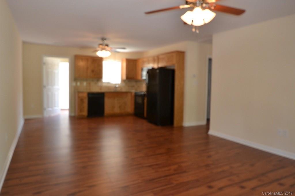 3835 Lee Moore Road, Unit 3835 Maiden, NC 28650 - Photo 9 of 19 an empty room with wooden floor and chandelier