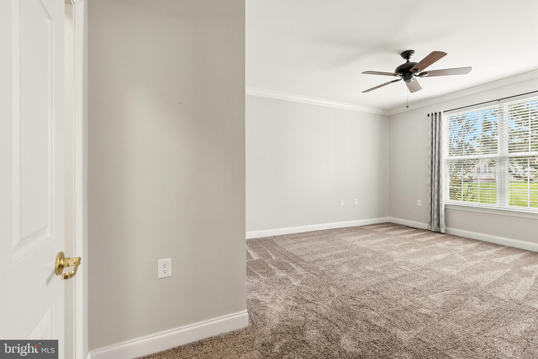 8 Spring Arbor Drive Middletown, DE 19709 - Photo 23 of 36 an empty room with a window and a ceiling fan