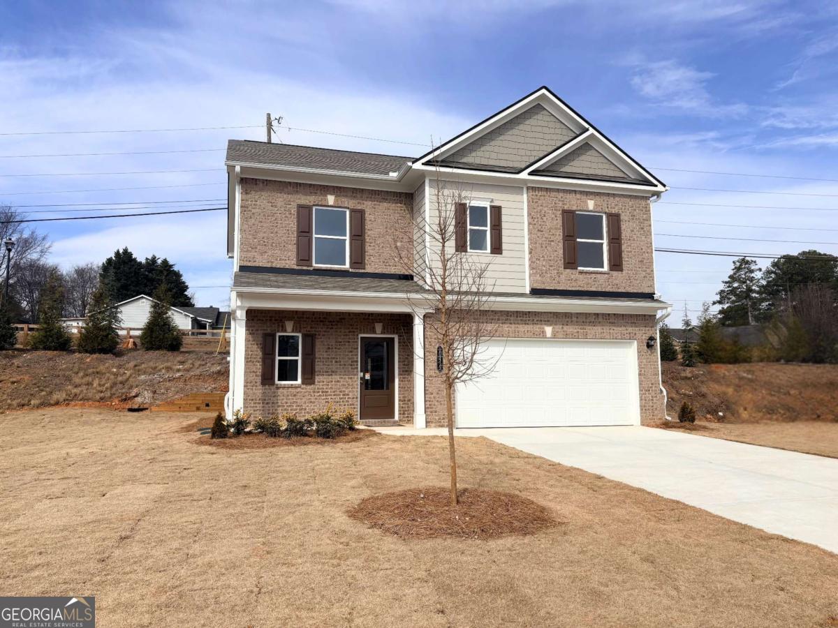 a front view of a house with a yard