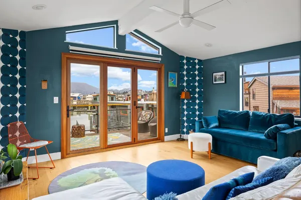 a living room filled with furniture and a floor to ceiling window