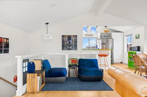 a dining room with furniture and wooden floor