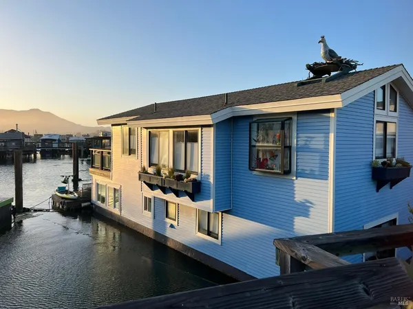 a view of a house with a balcony and door