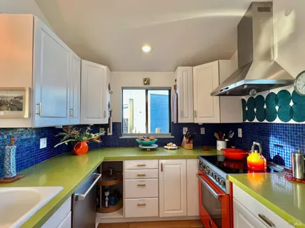 a kitchen with a sink a stove and cabinets