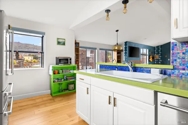 a bedroom with a bed and a dresser next to a window