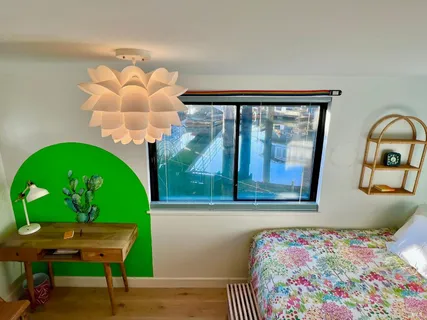 a bathroom with a granite countertop sink a mirror and a shower