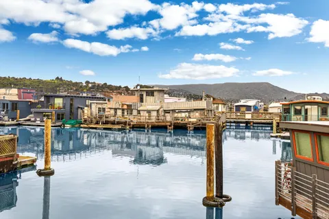a view of a house with pool and sitting area